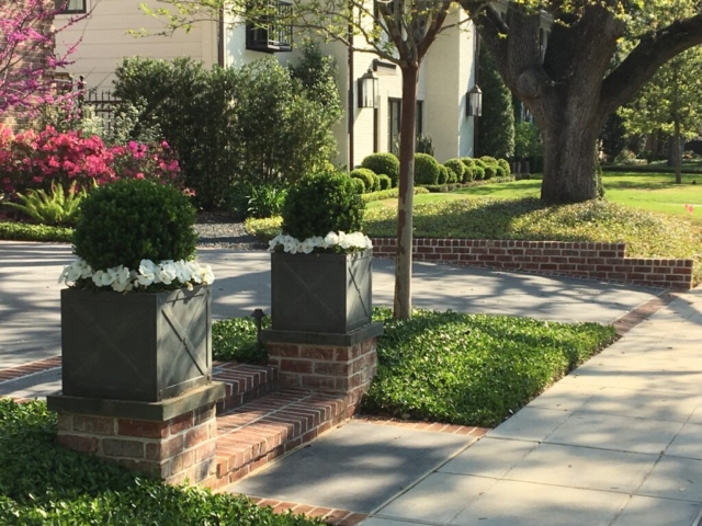 Planters with seasonal flowers added to walkway