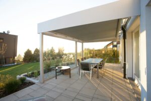 A backyard patio designed with an overhanging roof.